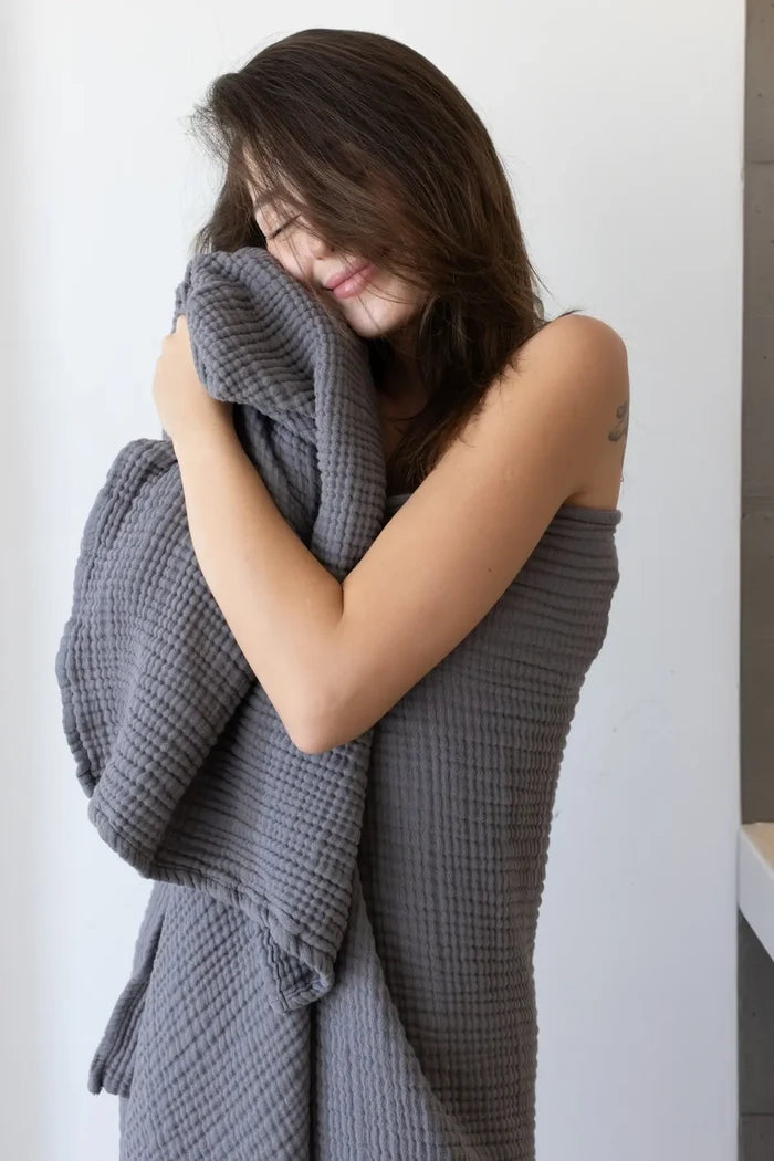 Anthracite muslin Turkish towel in a modern home scene, handwoven OEKO-TEX certified VivaMaison cotton