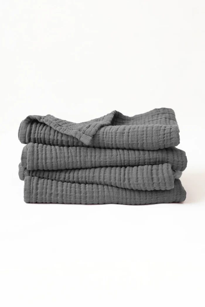 Stacked anthracite muslin Turkish cotton towels with soft 4-layer gauze weave, handwoven in Denizli