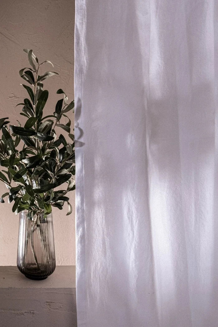 White stonewashed cotton curtain drape close-up with soft natural light. Handwoven in Denizli, OEKO-TEX. Vivamaison.