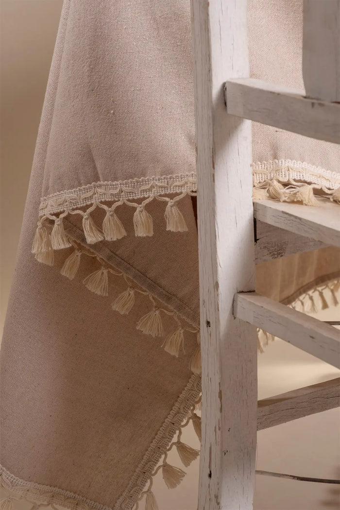 Beige handwoven solid color Turkish cotton tassel tablecloth overhead. Tasseled edges Denizli, OEKO-TEX. Vivamaison.